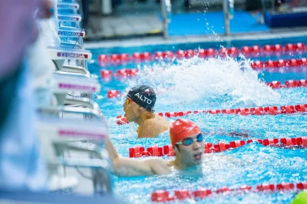 swimmer touching pool wall finish